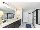 Bathroom featuring double vanity, stylish tile floors, and a large walk-in shower with a glass enclosure at 9920 Deep Royal Way, Indianapolis, IN 46239