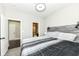 Comfortable bedroom with gray tones, a view to the bathroom, and natural light at 9920 Deep Royal Way, Indianapolis, IN 46239