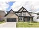 Charming two-story home with a brick and shingle exterior, black trim, and a well-manicured lawn at 9920 Deep Royal Way, Indianapolis, IN 46239