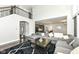 View of the living room leading into the kitchen with high ceilings and dark wood floors at 9920 Deep Royal Way, Indianapolis, IN 46239