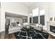 Open concept living room with high ceilings, large windows, fireplace, and view into kitchen area at 9920 Deep Royal Way, Indianapolis, IN 46239
