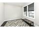 Bright and airy room featuring a geometric rug, a bench, and a window with modern blinds at 9920 Deep Royal Way, Indianapolis, IN 46239