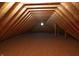 Spacious attic with exposed wood beams and round window, ready for your personal touch at 10138 Backstretch Row, Fishers, IN 46040