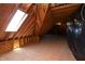 Spacious attic with exposed wood beams, skylight, and ample natural light, perfect for storage or conversion at 10138 Backstretch Row, Fishers, IN 46040