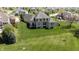 Aerial view highlighting the home's expansive backyard with lush green lawn and mature trees at 10138 Backstretch Row, Fishers, IN 46040