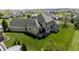 Aerial showing serene backyard view with ample green space, a deck, and neighborhood at 10138 Backstretch Row, Fishers, IN 46040