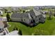 Aerial view of the home’s serene backyard with ample green space and a charming deck for relaxation at 10138 Backstretch Row, Fishers, IN 46040