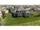 Spacious backyard with manicured lawn, mature landscaping, and deck, perfect for outdoor enjoyment at 10138 Backstretch Row, Fishers, IN 46040