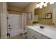 Bright bathroom featuring a vanity with a white sink and shower with white tile and neutral paint at 10138 Backstretch Row, Fishers, IN 46040