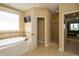 Bright bathroom with soaking tub, tile surround, and separate shower at 10138 Backstretch Row, Fishers, IN 46040