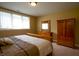 Comfortable bedroom featuring natural light, a wooden bed frame, dresser with mirror, and ample closet space at 10138 Backstretch Row, Fishers, IN 46040