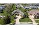 Beautiful front elevation of the home featuring manicured lawn, elegant landscaping, and curved driveway to the two-car garage at 10138 Backstretch Row, Fishers, IN 46040