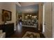 Inviting foyer showcasing hardwood floors leading to a dining area and with a front door to the right at 10138 Backstretch Row, Fishers, IN 46040