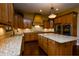 Gourmet kitchen with granite countertops, stainless steel appliances, custom cabinets, and a decorative range hood at 10138 Backstretch Row, Fishers, IN 46040