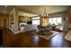 Inviting living space showcasing hardwood floors, an open layout, fireplace, dining area, and gourmet kitchen at 10138 Backstretch Row, Fishers, IN 46040