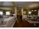 Open-concept living space with hardwood floors, a dining area, and a cozy living room with a fireplace at 10138 Backstretch Row, Fishers, IN 46040