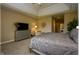 Bright main bedroom with plush carpeting, tray ceiling, and large dresser at 10138 Backstretch Row, Fishers, IN 46040