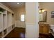 Convenient mudroom with custom built-in storage, powder room, and access to the garage for seamless organization at 10138 Backstretch Row, Fishers, IN 46040