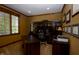 A well-lit home office features custom built-ins, a large desk, and a serene view through the blinds at 10138 Backstretch Row, Fishers, IN 46040
