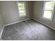 Bright bedroom featuring neutral walls, plush gray carpet, and two windows offering ample natural light at 1019 E Jackson St, Shelbyville, IN 46176
