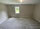 Carpeted bedroom featuring fresh paint, natural light, and a pleasant atmosphere at 1019 E Jackson St, Shelbyville, IN 46176