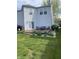 Backyard featuring a wooden deck with patio seating, plants, well-maintained lawn and siding in a residential area at 10190 Holly Berry Cir, Fishers, IN 46038