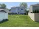 Spacious backyard with patio, surrounded by well-maintained grass and enclosed by a combination of wooden and vinyl fences at 10190 Holly Berry Cir, Fishers, IN 46038