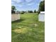 Expansive backyard with well-maintained grass, enclosed by both wooden and white vinyl fences, in a residential neighborhood at 10190 Holly Berry Cir, Fishers, IN 46038