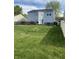 Backyard featuring a wooden deck with patio seating, well-maintained lawn and wood privacy fence at 10190 Holly Berry Cir, Fishers, IN 46038