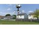 Large birdhouse installation on a post, surrounded by green grass and houses at 10190 Holly Berry Cir, Fishers, IN 46038