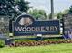 Stone monument sign for the Woodberry community with lush green landscaping at 10190 Holly Berry Cir, Fishers, IN 46038