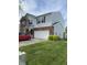 Two-story home with a brick and vinyl exterior, attached two-car garage, and a well-maintained lawn at 10190 Holly Berry Cir, Fishers, IN 46038