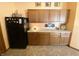 Functional kitchen with wood cabinets and a black refrigerator at 10190 Holly Berry Cir, Fishers, IN 46038