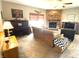 Inviting living room featuring a brick fireplace, piano, and comfortable seating at 10190 Holly Berry Cir, Fishers, IN 46038
