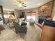 Cozy living room featuring a warm fireplace, comfortable seating, and abundant natural light at 10190 Holly Berry Cir, Fishers, IN 46038