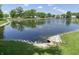Community pond with mature trees, and a stone embankment at 10190 Holly Berry Cir, Fishers, IN 46038