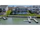 An aerial view shows a lake house with a backyard featuring a pool and a private dock at 10590 Geist View Dr, Fishers, IN 46055