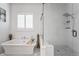 Bright bathroom featuring a free-standing tub and glass-enclosed shower at 10590 Geist View Dr, Fishers, IN 46055