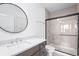 Modern bathroom with sleek vanity, large mirror, and glass-enclosed shower at 10590 Geist View Dr, Fishers, IN 46055