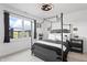 Bedroom featuring a four-poster bed, large window, and neutral décor at 10590 Geist View Dr, Fishers, IN 46055