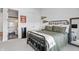 Well-lit bedroom with sleek black furniture, a full size mirror, and easy access to the bathroom at 10590 Geist View Dr, Fishers, IN 46055
