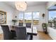 Dining room with modern chandelier and a large window view of the water at 10590 Geist View Dr, Fishers, IN 46055