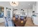Dining room with view into the kitchen and outdoor patio at 10590 Geist View Dr, Fishers, IN 46055