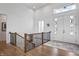 Bright foyer with hardwood floors, decorative staircase, and a modern front door at 10590 Geist View Dr, Fishers, IN 46055