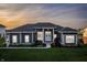 Beautiful home exterior featuring a well-maintained lawn, elegant landscaping, and a welcoming entrance with double doors at 10590 Geist View Dr, Fishers, IN 46055