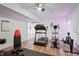 Bright home gym with treadmill, elliptical, weight bench, and durable flooring at 10590 Geist View Dr, Fishers, IN 46055