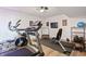 Home gym featuring a treadmill, elliptical, weight bench, and durable flooring at 10590 Geist View Dr, Fishers, IN 46055