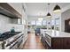 Spacious kitchen with a large island, stainless steel appliances, and a view of the water at 10590 Geist View Dr, Fishers, IN 46055