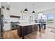Gourmet kitchen featuring a large island with a marble countertop and high-end stainless steel appliances at 10590 Geist View Dr, Fishers, IN 46055