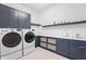 Functional laundry room with modern washer and dryer, plus ample counter and cabinet space at 10590 Geist View Dr, Fishers, IN 46055